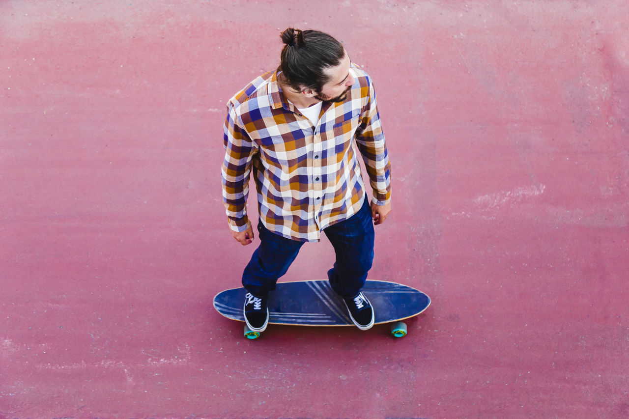 High angle view of man standing on skateboard