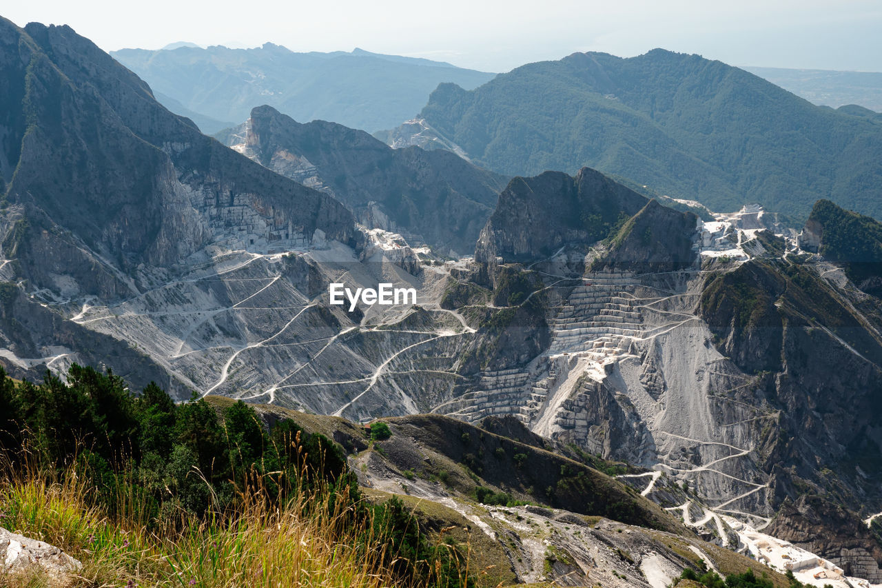 View of the carrara marble quarries and the transport trails carved into the side of the mountain.