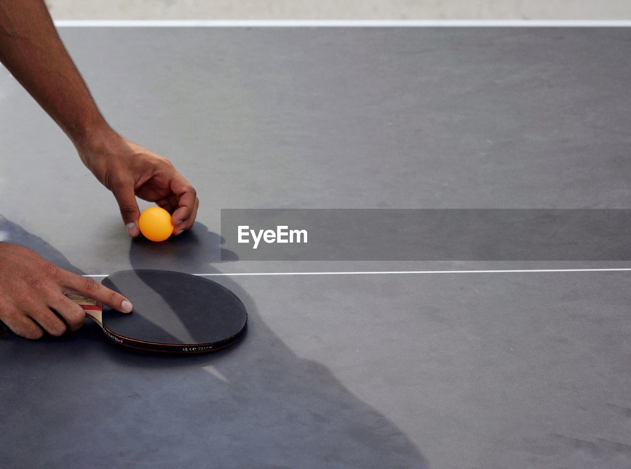 Cropped hands playing table tennis