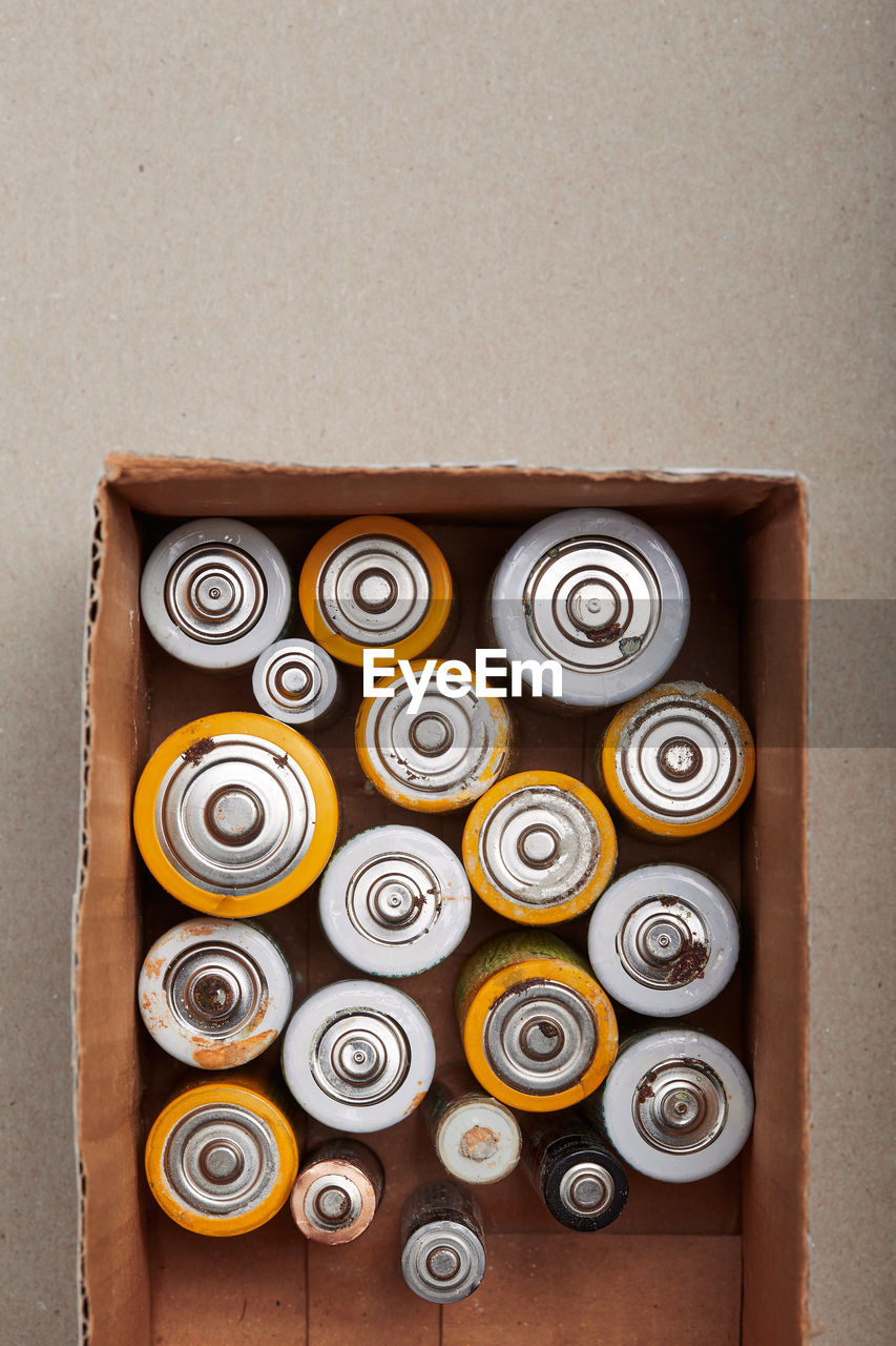 Discharged batteries in cardboard box. collecting used batteries to recycle