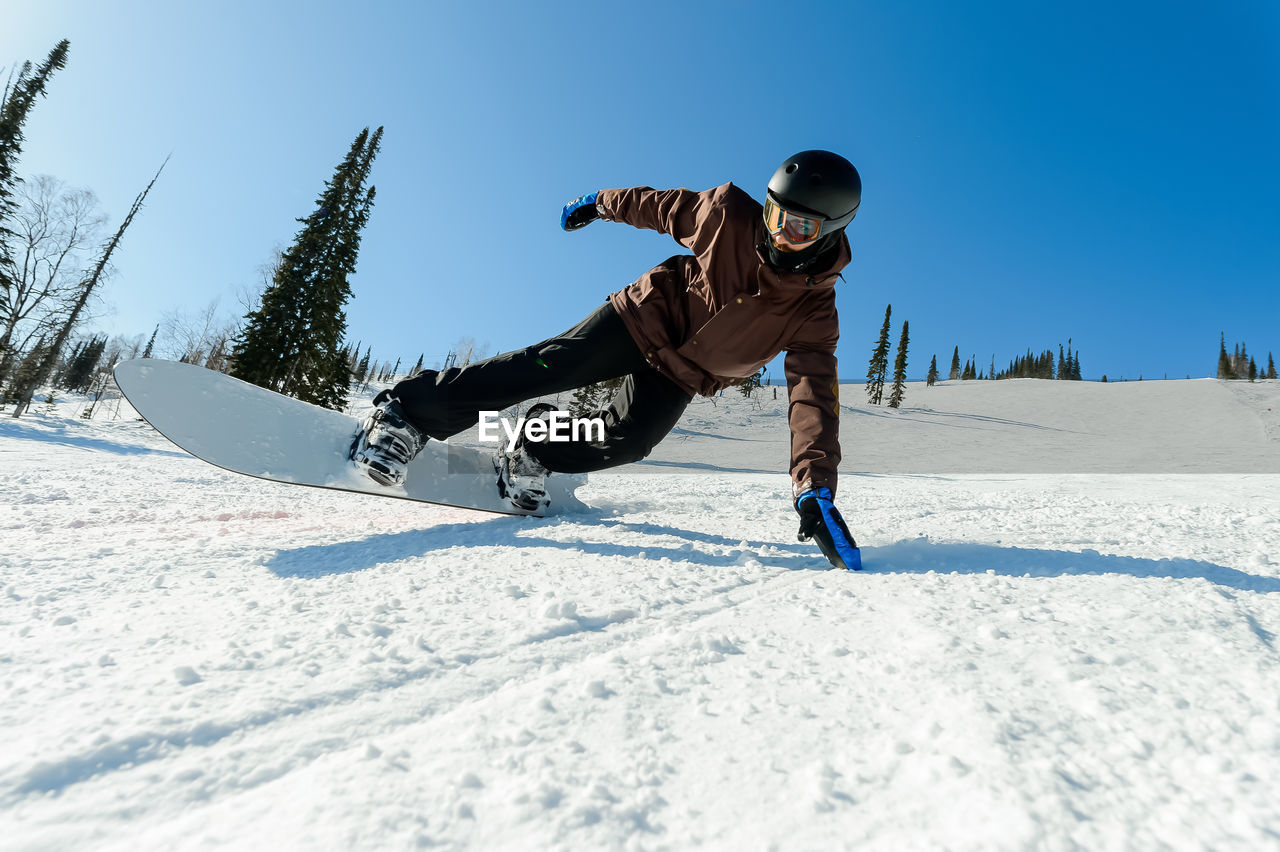 Full length of man snowboarding against sky