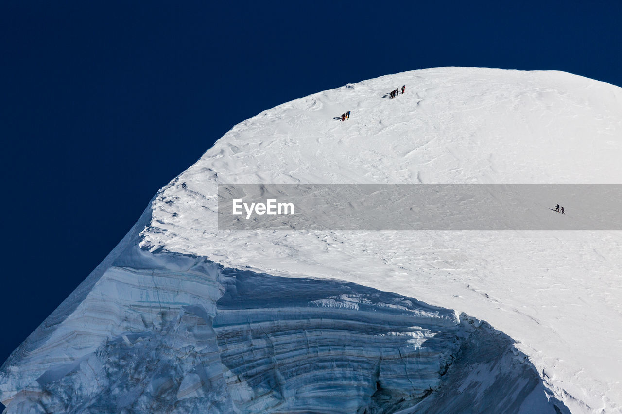 Scenic view of snowcapped mountains against clear blue sky. view from klein matterhorn, swiss alps
