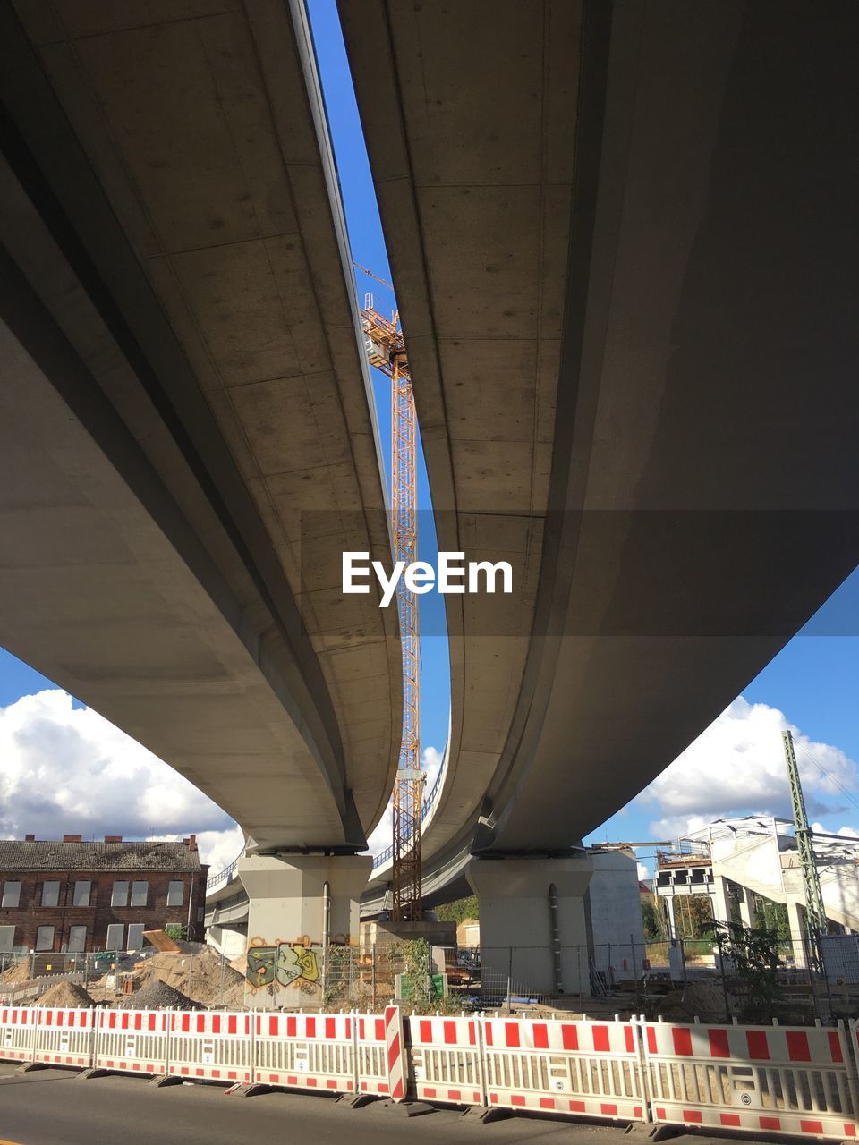 LOW ANGLE VIEW OF BRIDGE OVER CITY BUILDINGS