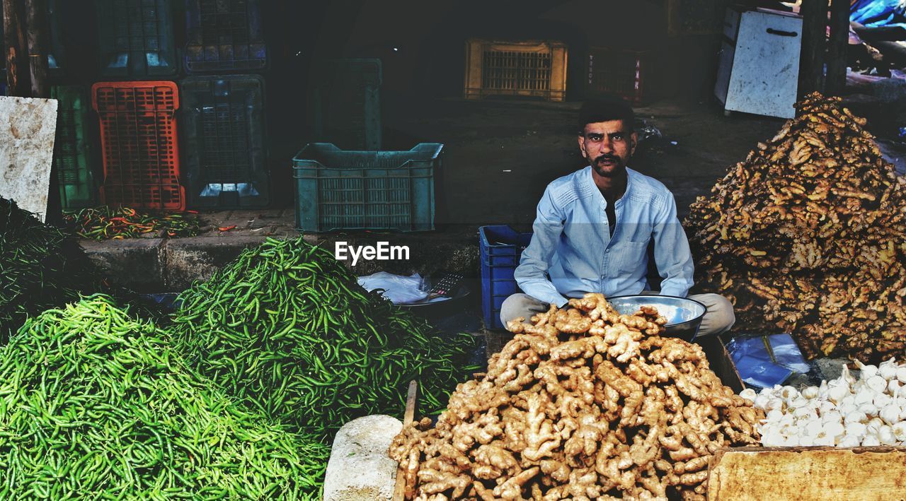 Portrait of vendor with vegetables in market