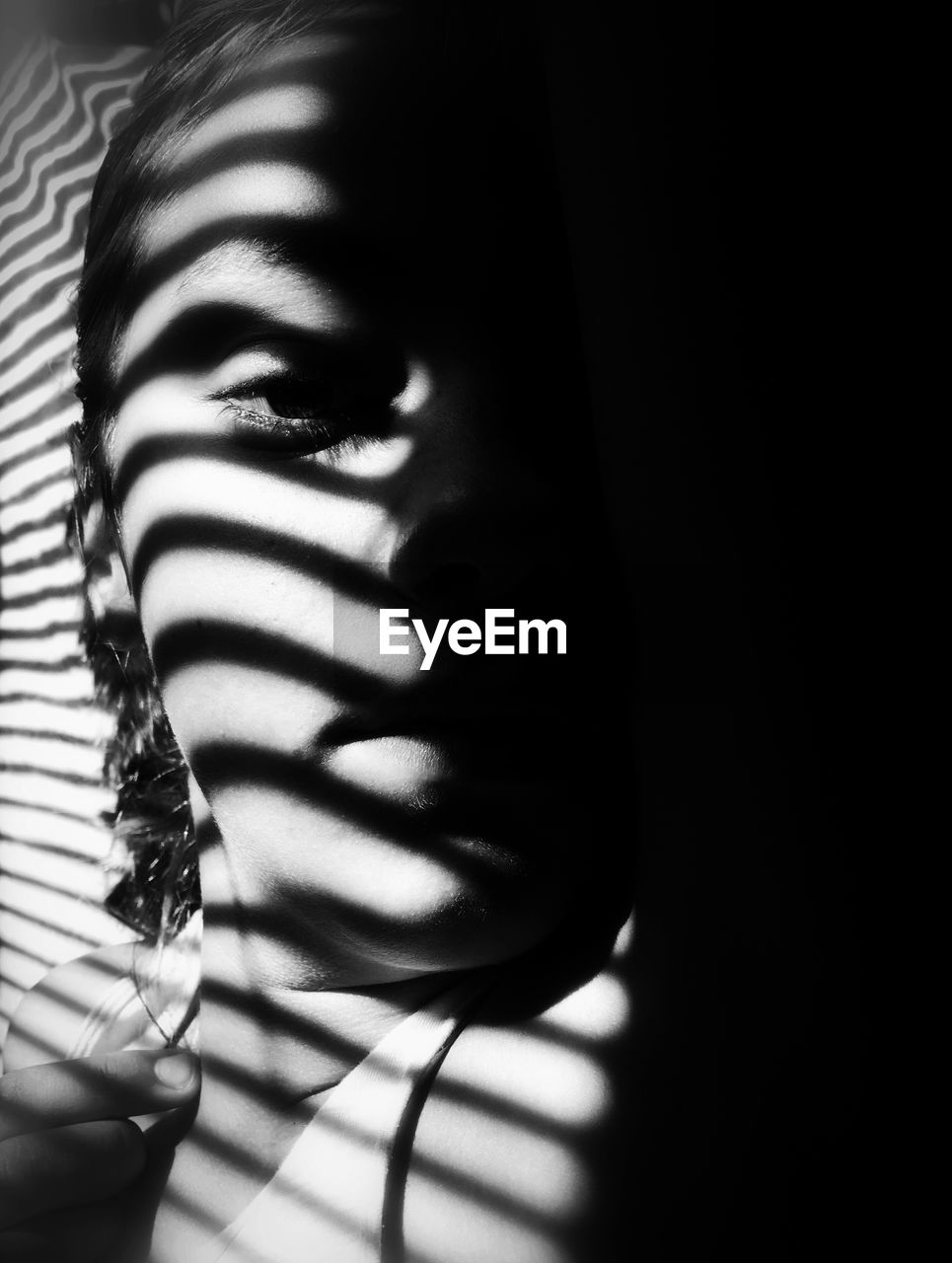 Close-up portrait of woman with shadow