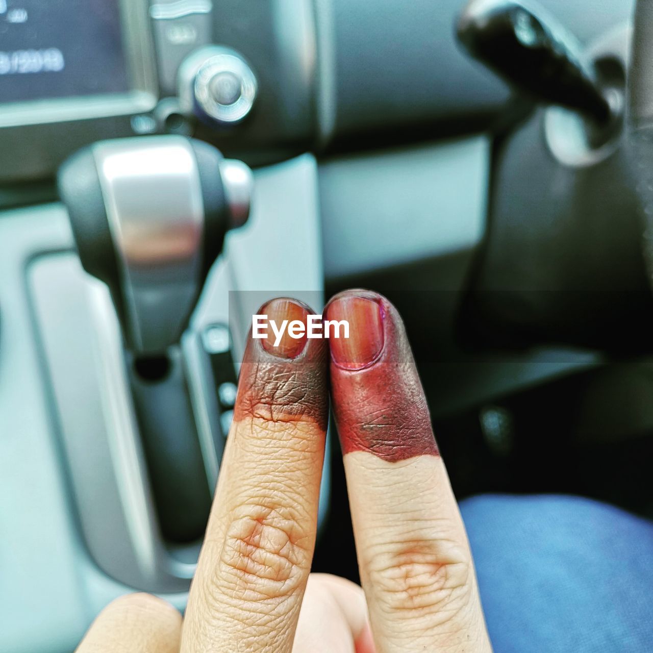 Cropped image of man and woman fingers in car