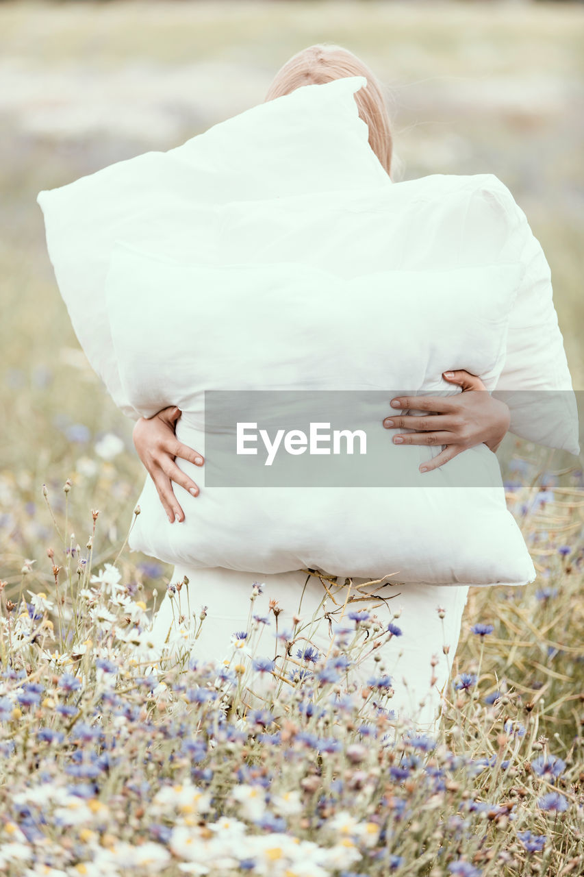 Midsection of woman with umbrella on land