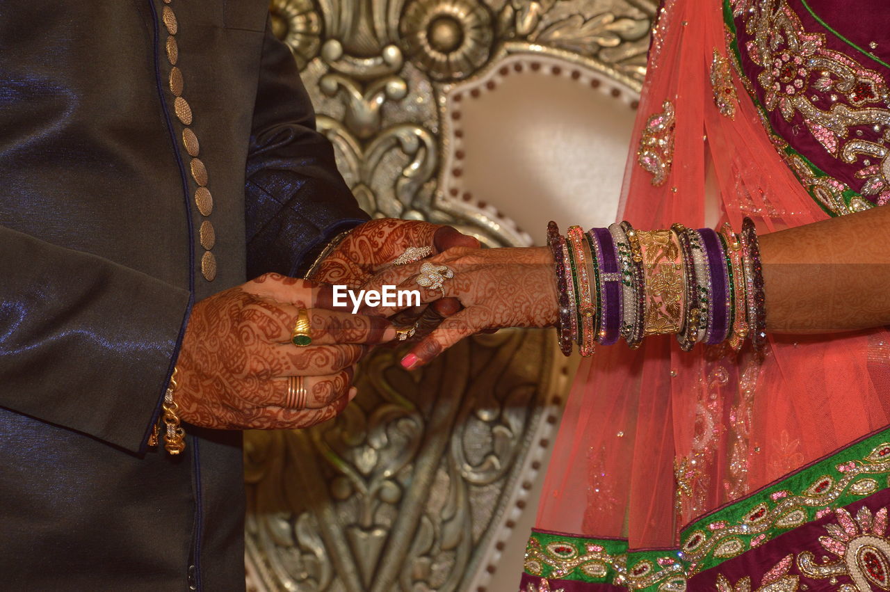 Couple holding hands on indian wedding
