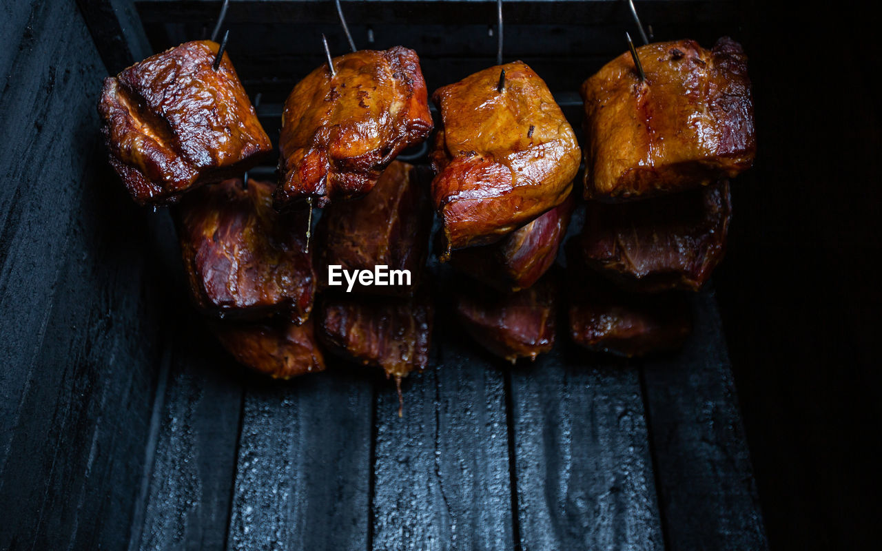 food, food and drink, meat, freshness, no people, barbecue, healthy eating, indoors, grilled, grilling, wellbeing, roasted, pork, close-up, produce, dish, still life, wood, high angle view, meal