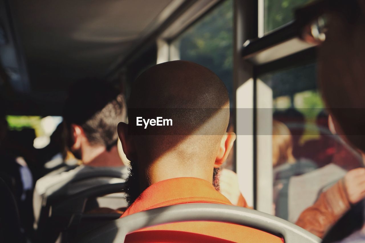 Rear view of people sitting in bus