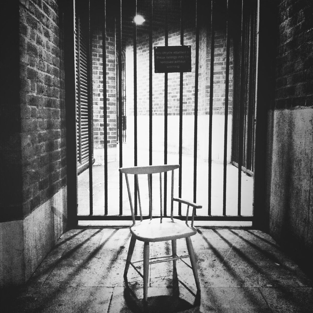 Empty chair against bars