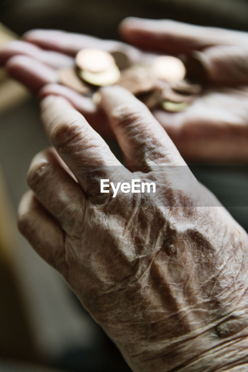 Senior woman's hands with coins