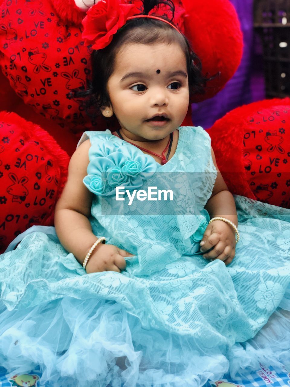 Portrait of cute baby boy as girl makeover