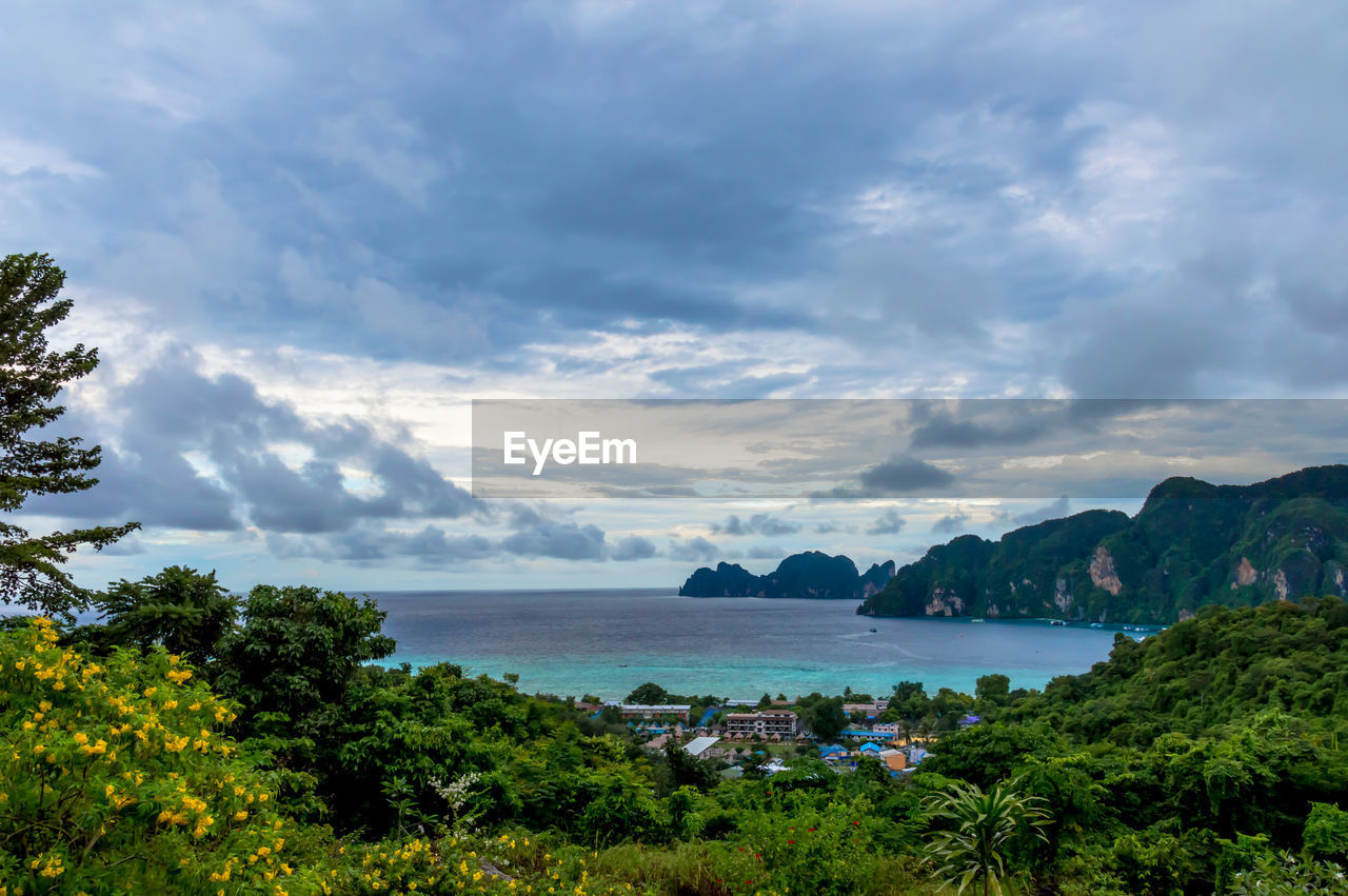 Scenic view of mountains by sea against cloudy sky at ko phi phi le island