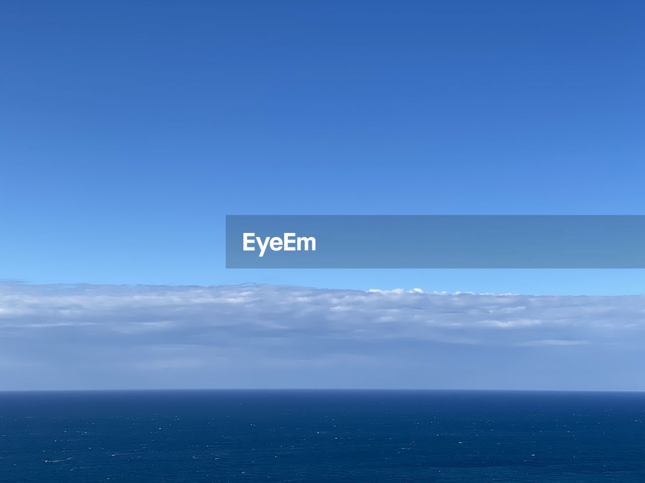 VIEW OF SEA AGAINST BLUE SKY