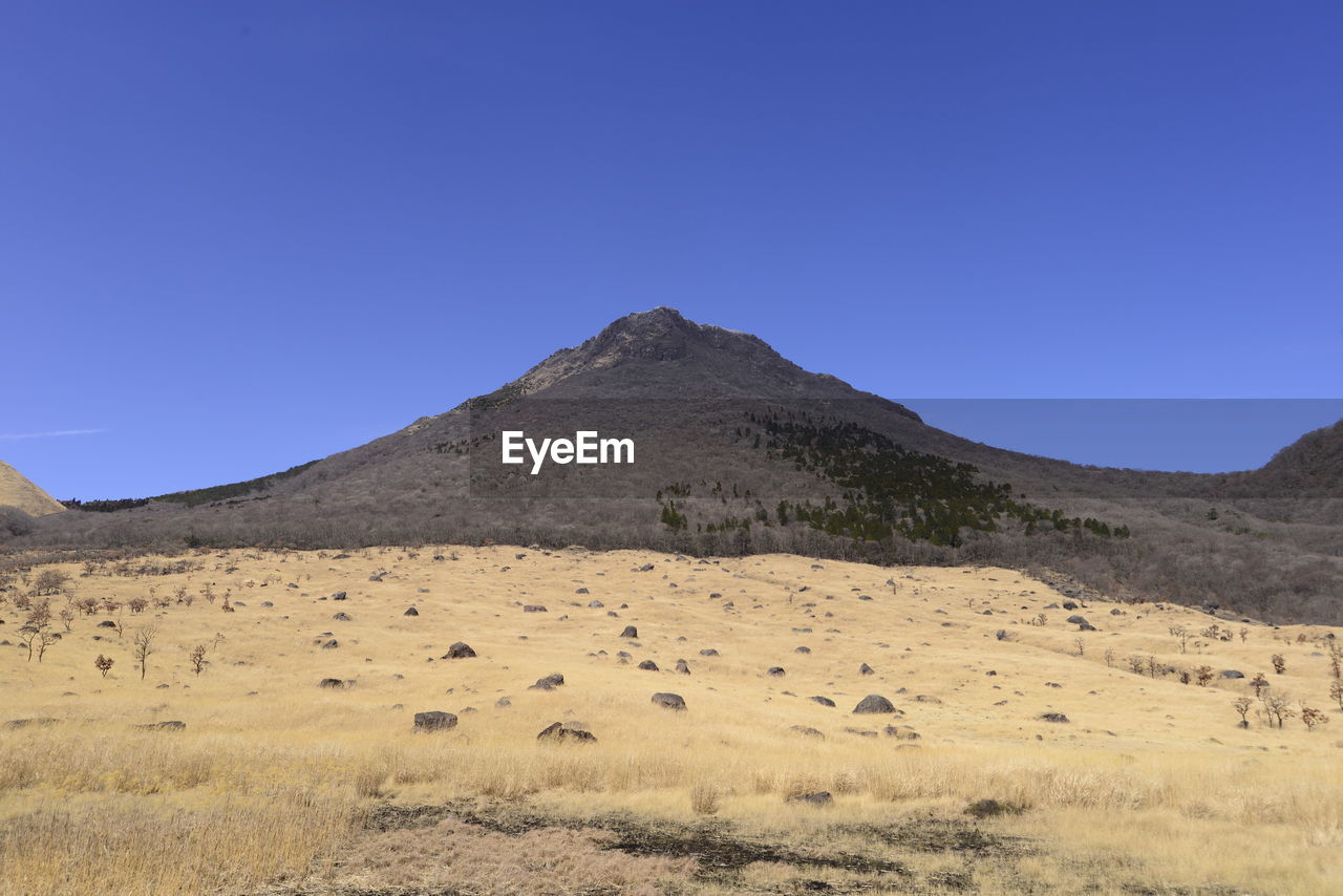 SCENIC VIEW OF MOUNTAIN AGAINST BLUE SKY