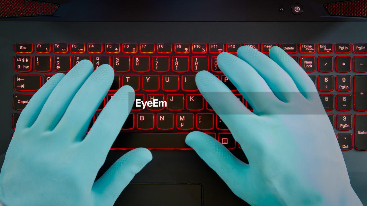 Cropped image of person using laptop