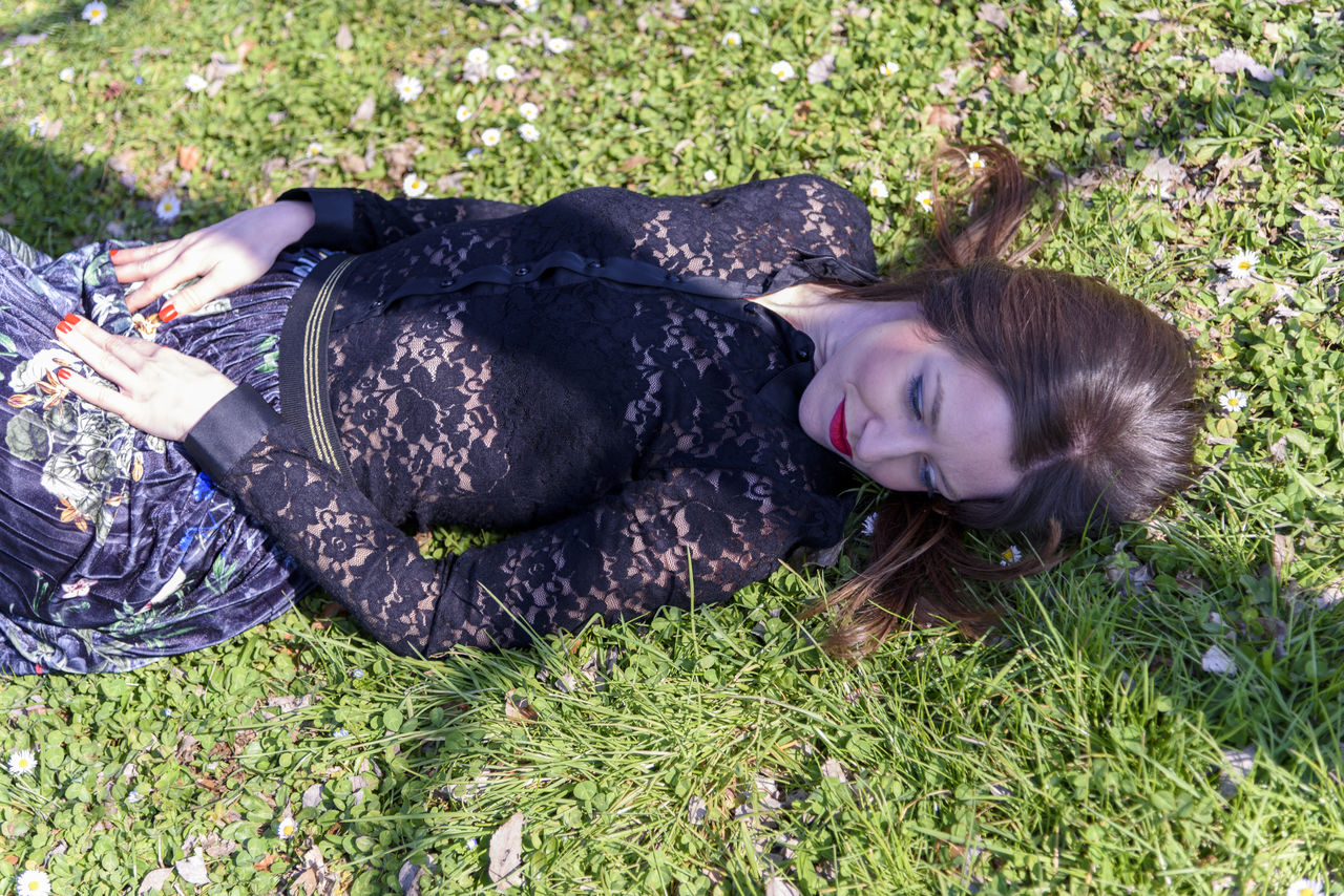 HIGH ANGLE VIEW OF WOMAN LYING ON FIELD