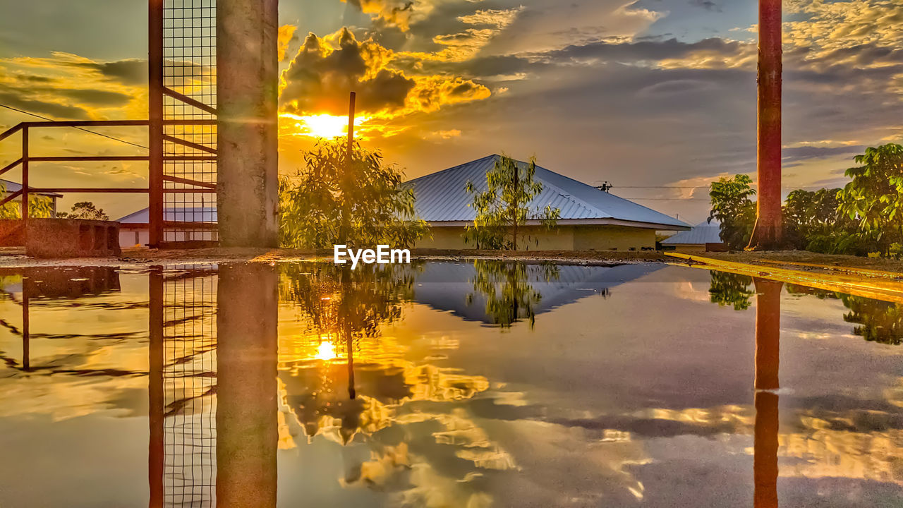 SCENIC VIEW OF LAKE AGAINST ORANGE SKY