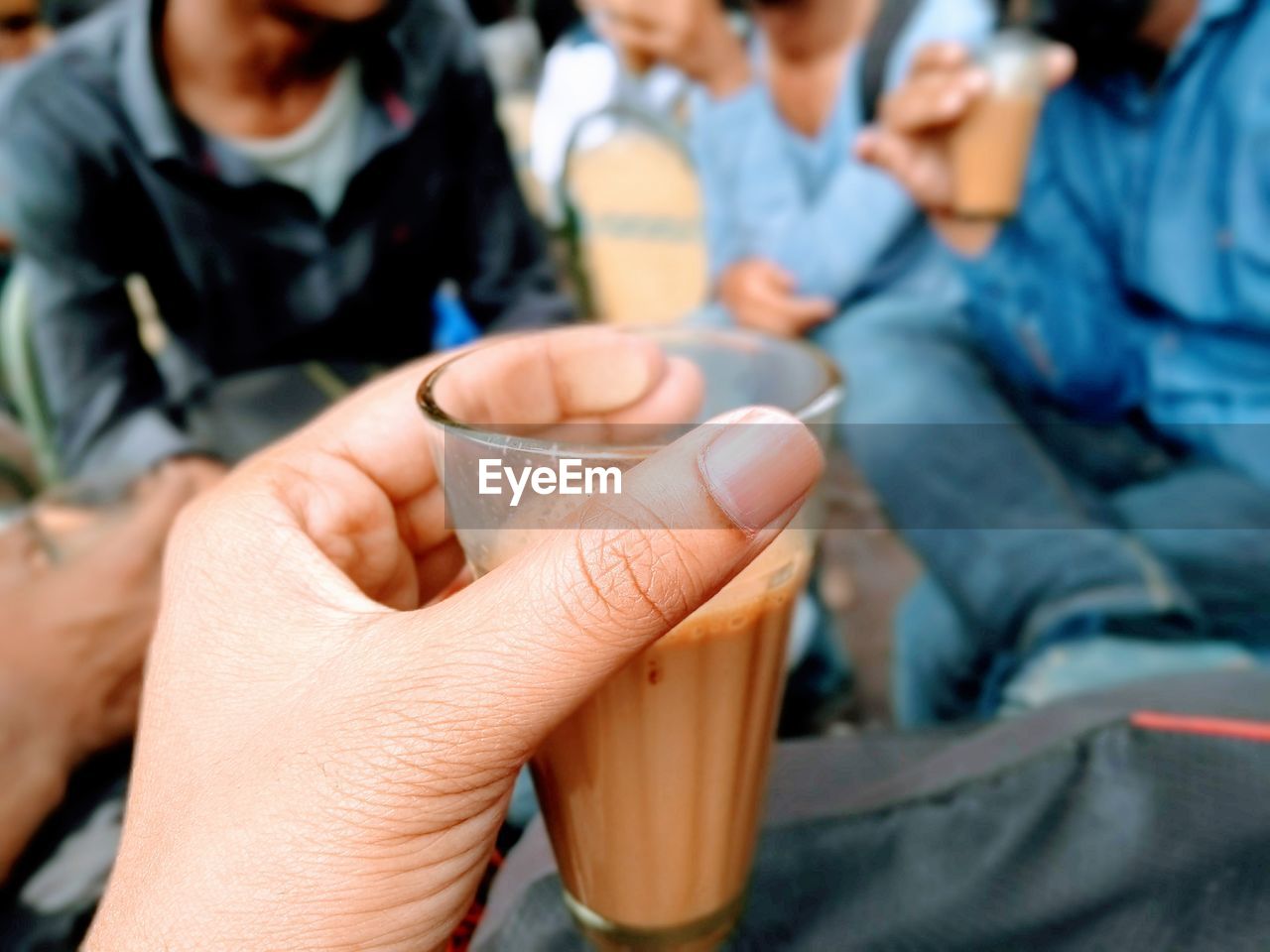 Midsection of people holding drink