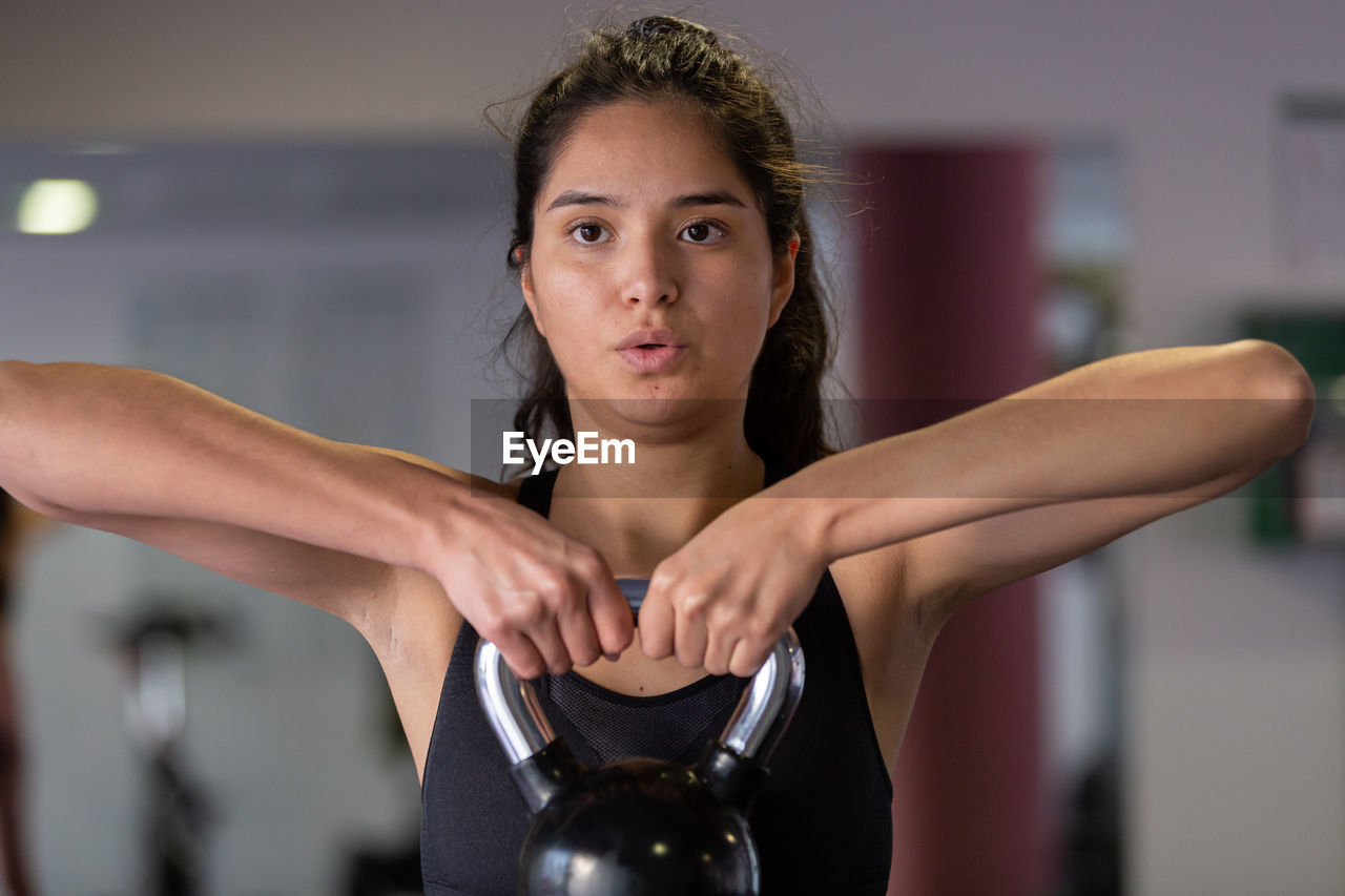 young woman exercising at gym