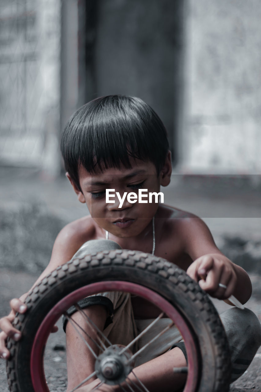Boy playing with tire