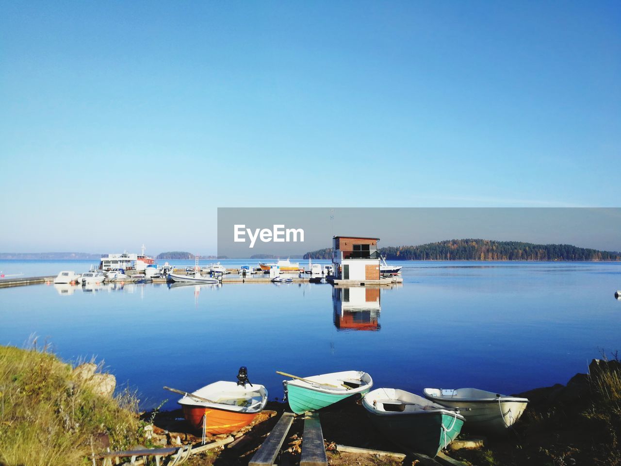 Scenic view of lake against clear blue sky