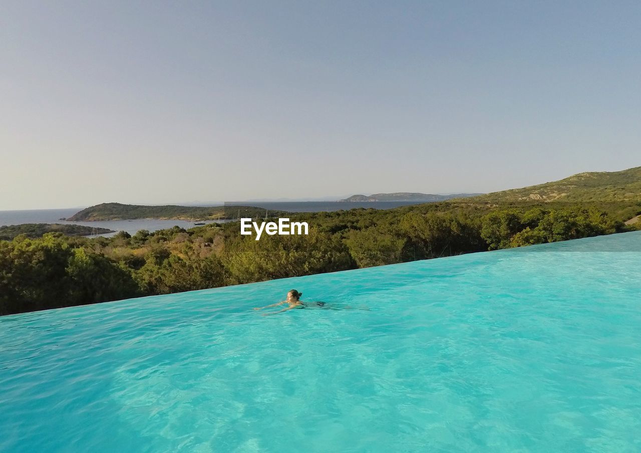SCENIC VIEW OF SWIMMING POOL AGAINST CLEAR SKY