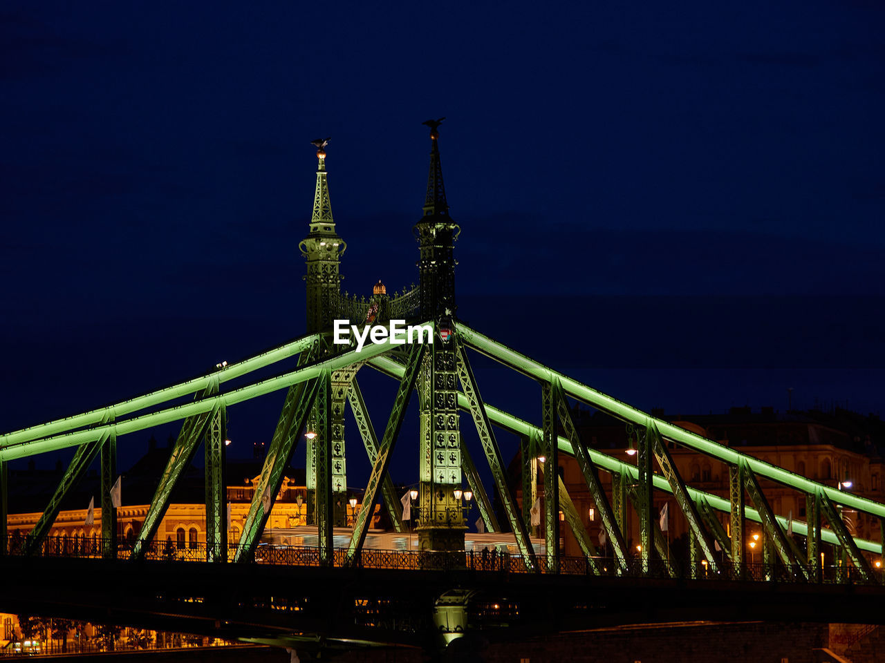 Illuminated bridge against sky at night