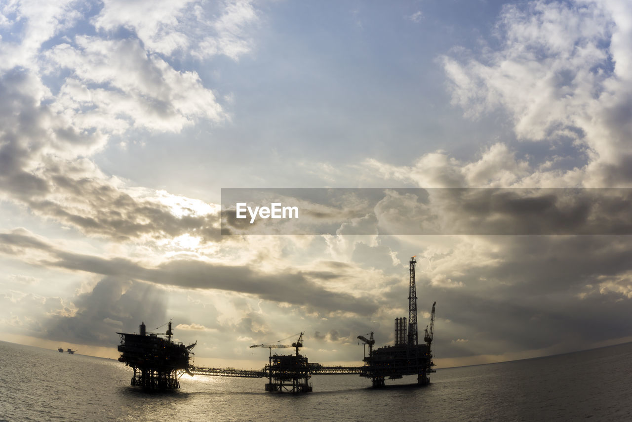 Silhouette of an oil production platforms during sunset at offshore terengganu oil field