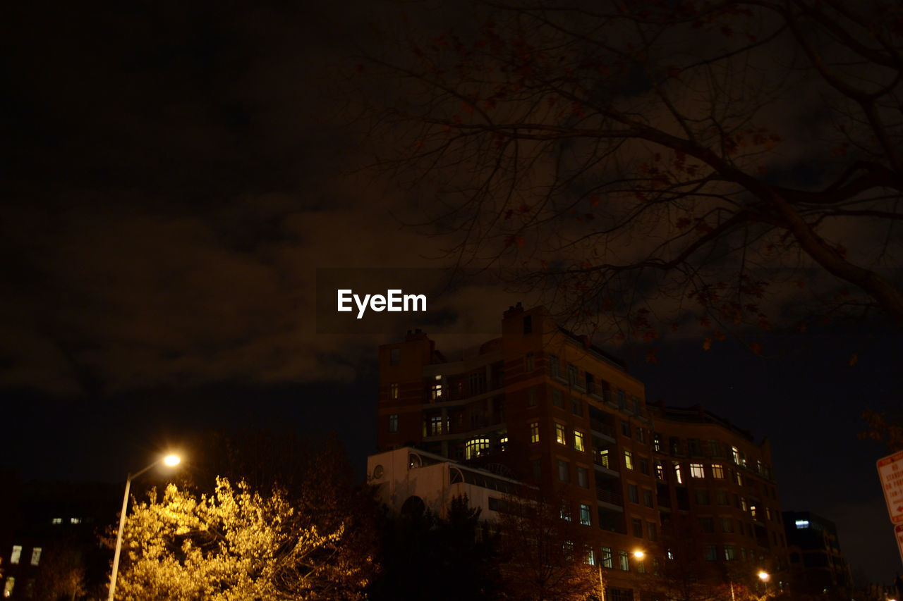 ILLUMINATED BUILDINGS AGAINST SKY AT NIGHT