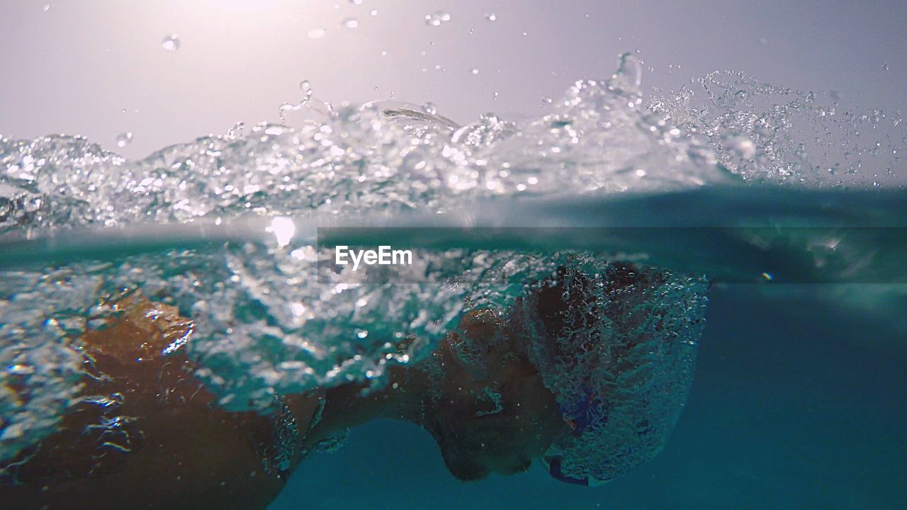 Close-up of man swimming undersea