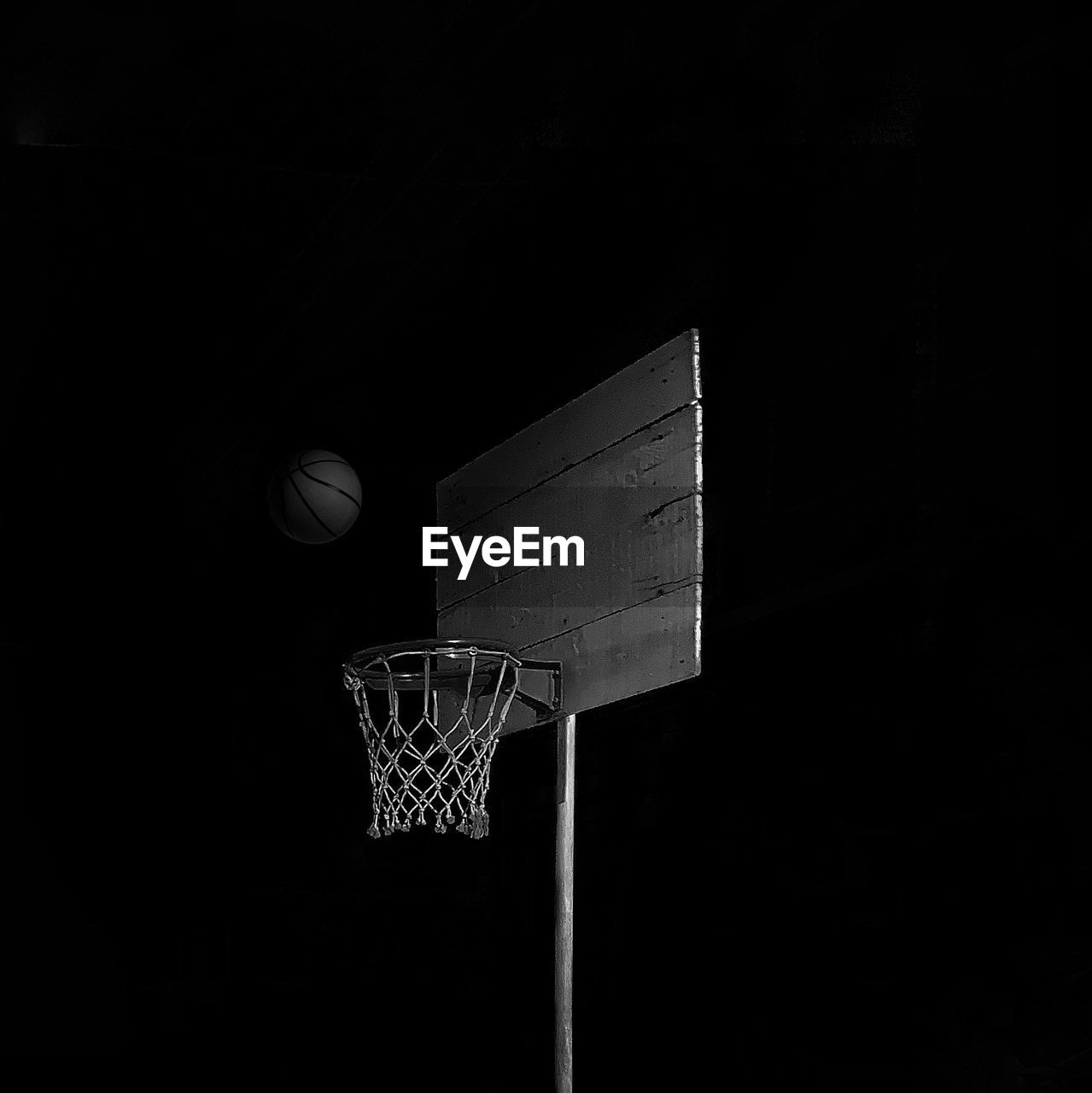 Low angle view of basketball hoop against sky at night