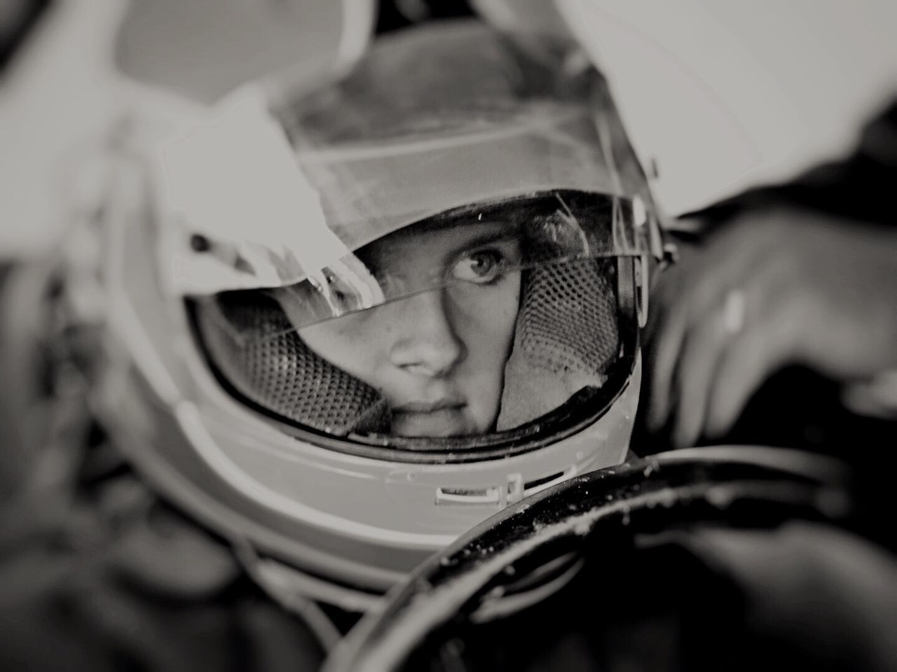Close-up of girl sitting in racing car