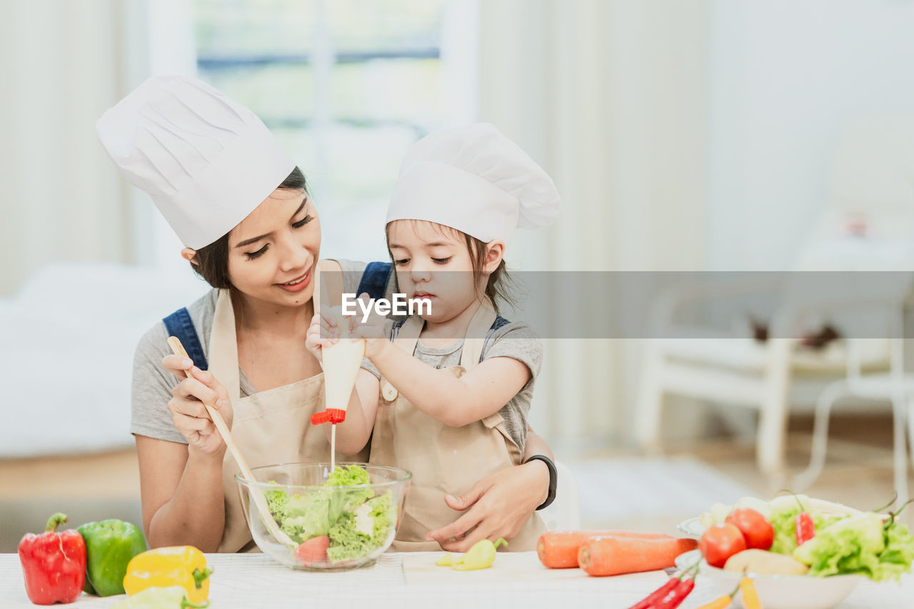 MIDSECTION OF WOMAN WITH ICE CREAM