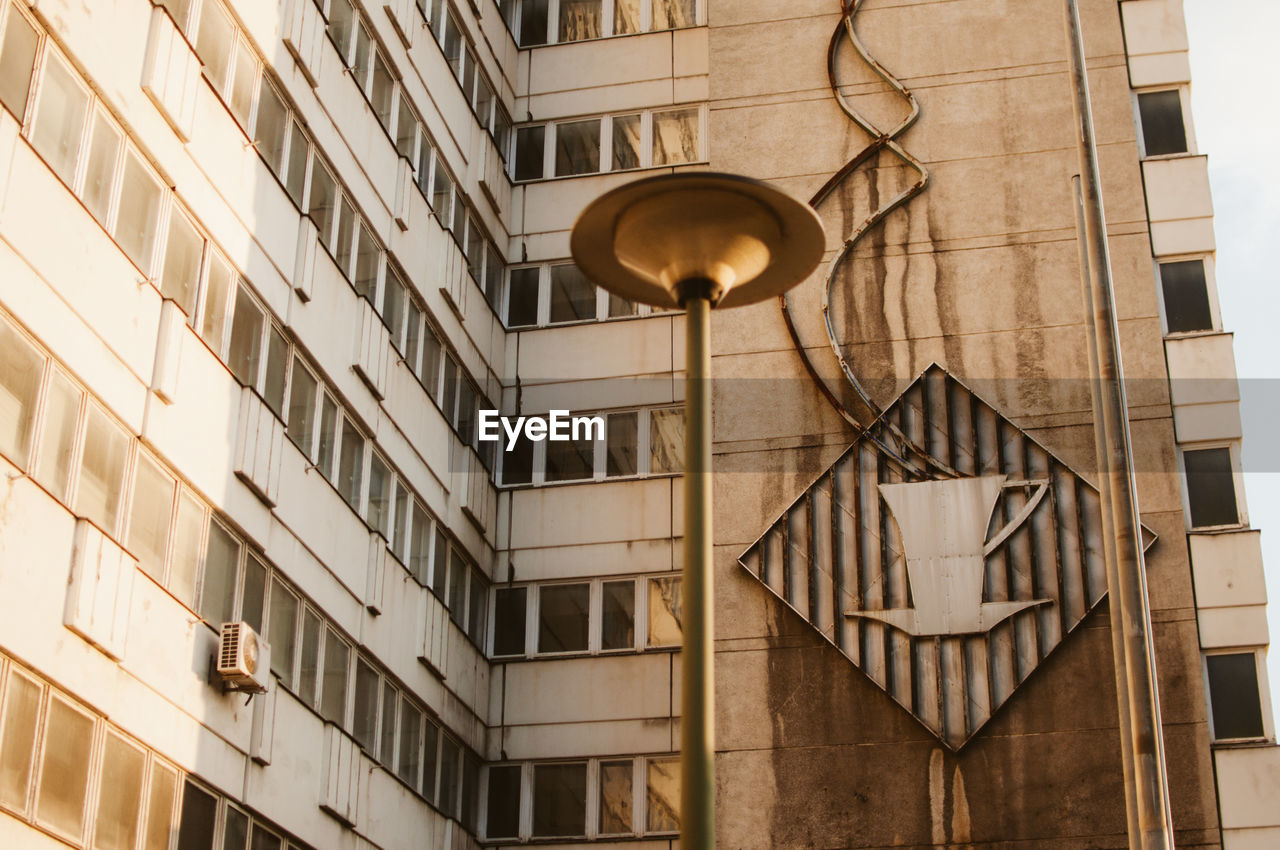 Low angle view of street light against building