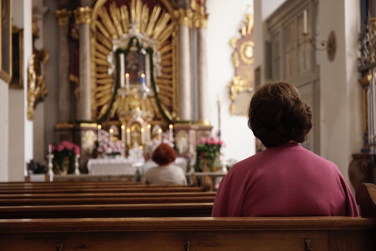 Rear view of a woman sitting in church