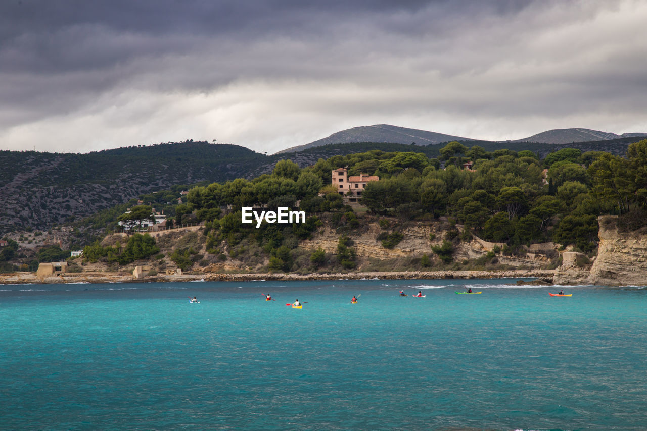 SCENIC VIEW OF SEA BY MOUNTAIN AGAINST SKY
