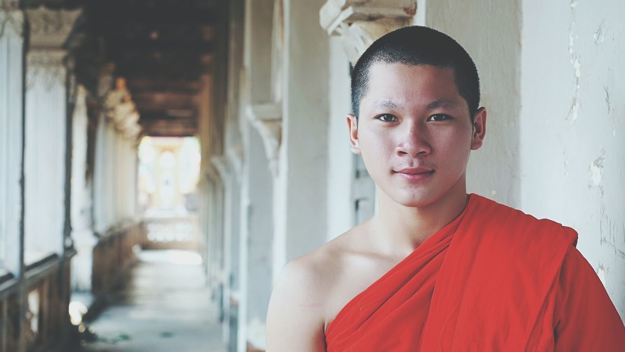 Portrait of monk standing in temple