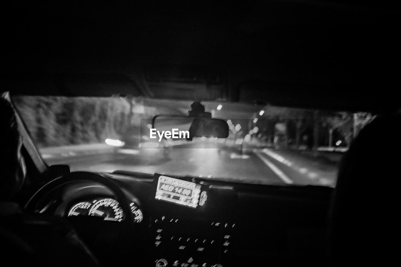 Interior of car on road at night