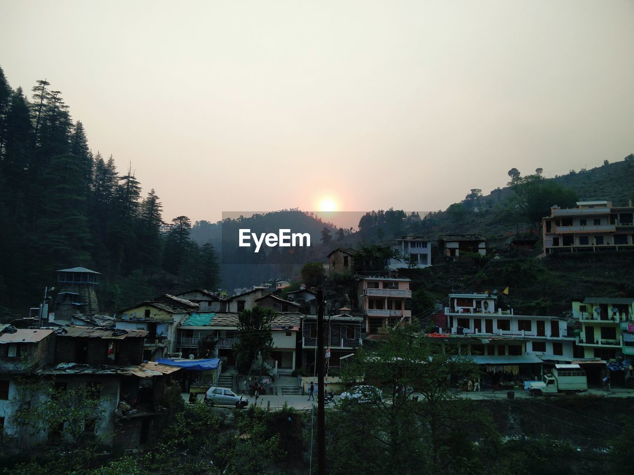 HIGH ANGLE VIEW OF HOUSES IN TOWN AT SUNSET