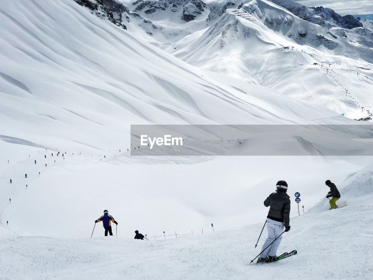 People skiing on snowcapped mountain in lech 