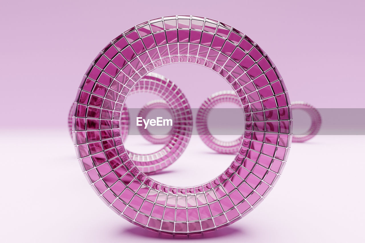 Textured object against pink background