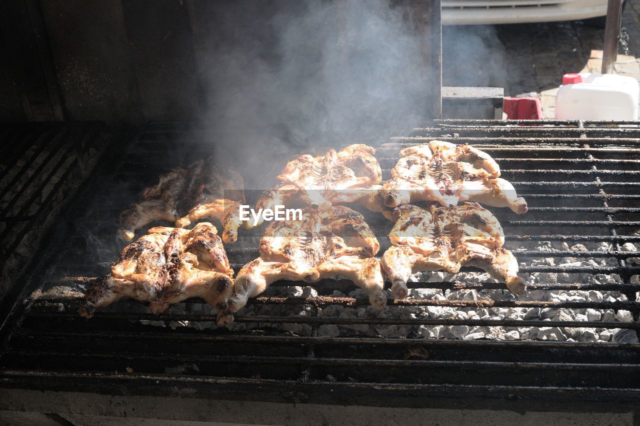 High angle view of chicken being cooked on barbecue grill