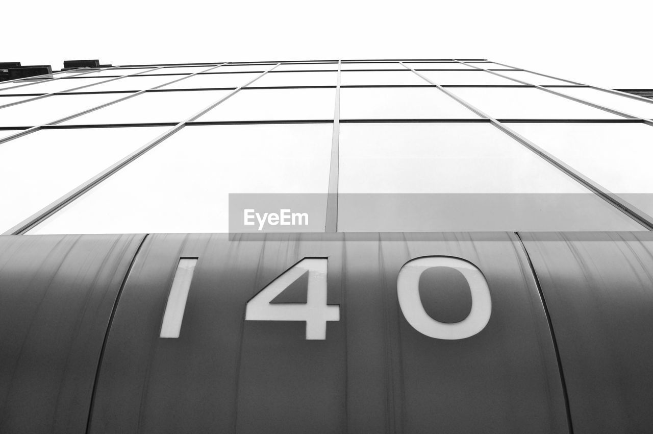 Low angle view of numbers on building against sky