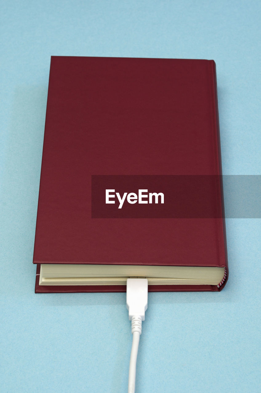 CLOSE-UP OF RED OPEN BOOK