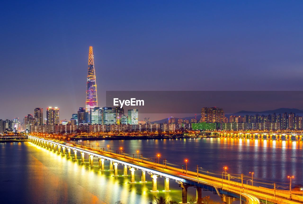 ILLUMINATED BUILDINGS IN CITY AT NIGHT