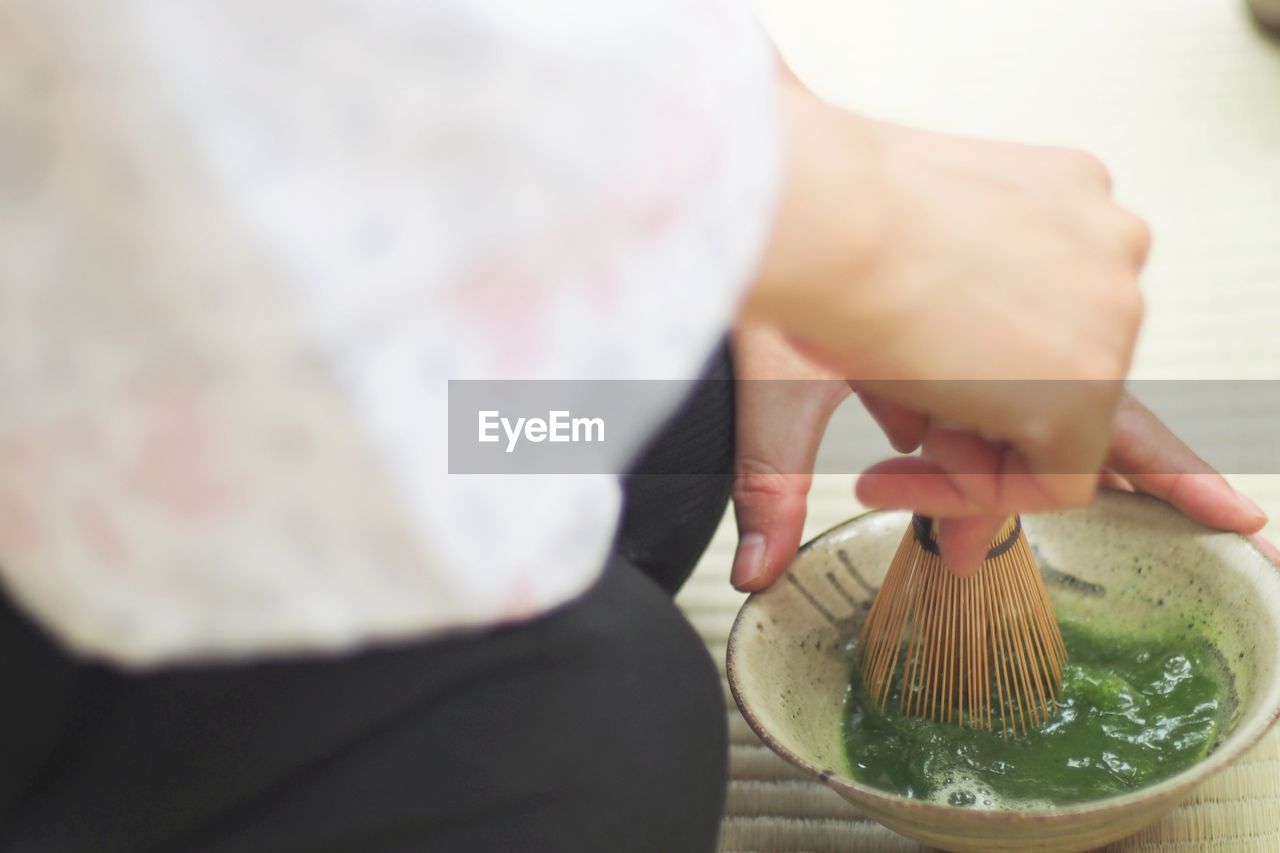 Close-up of woman making green tea