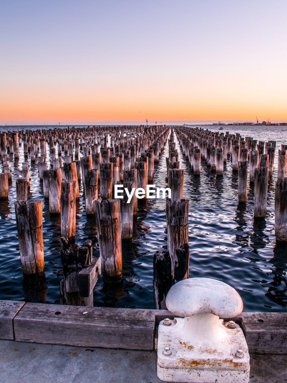 Historic wooden piles of princes pier in melbourne at sunset