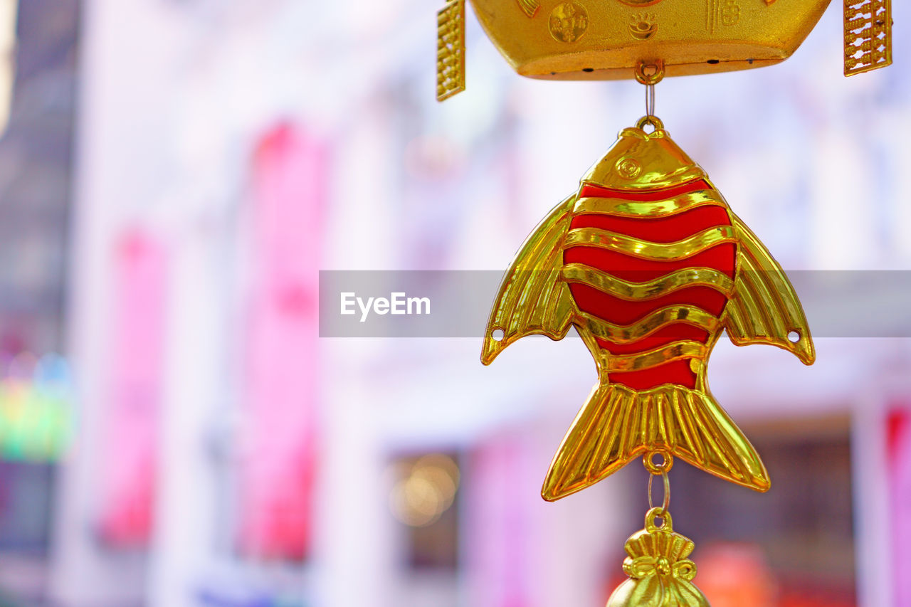 Close-up of multi colored decoration hanging outside temple